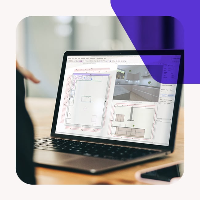 An individual engaged in designing a kitchen on a laptop