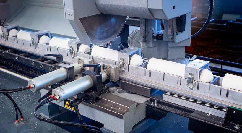 A machine precisely cutting a sheet of paper.