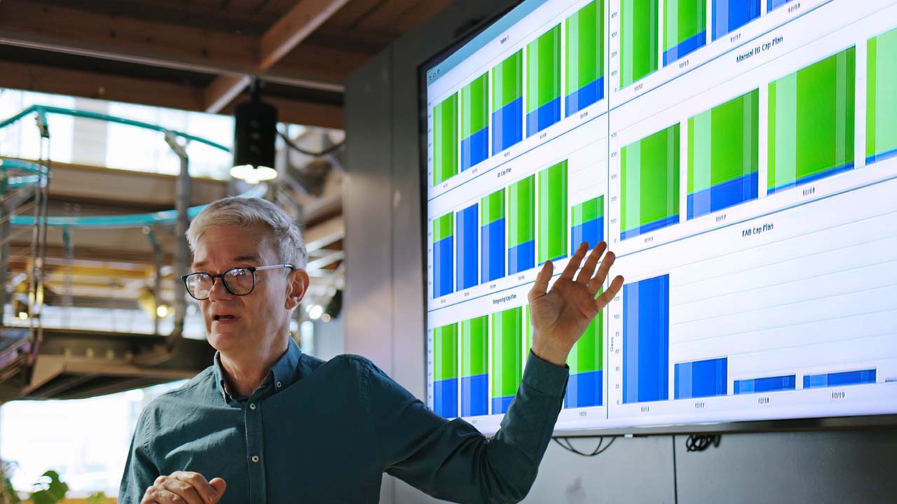 A man actively analyzing the displayed information on the screen.