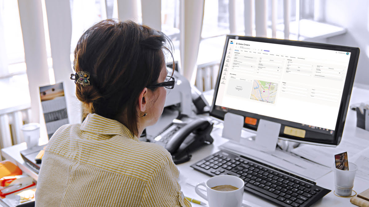 A woman at a desk, focused on her computer