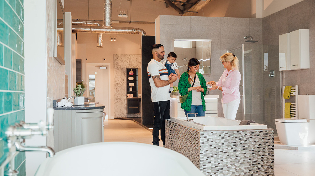 A family in the bathroom showroom