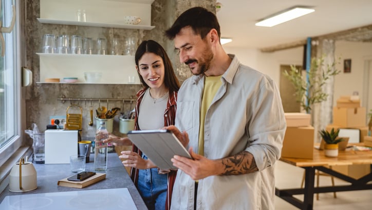 A couple is choosing a kitchen on the tablet