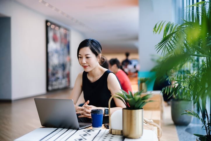 Young woman taking an online training course in a public space.