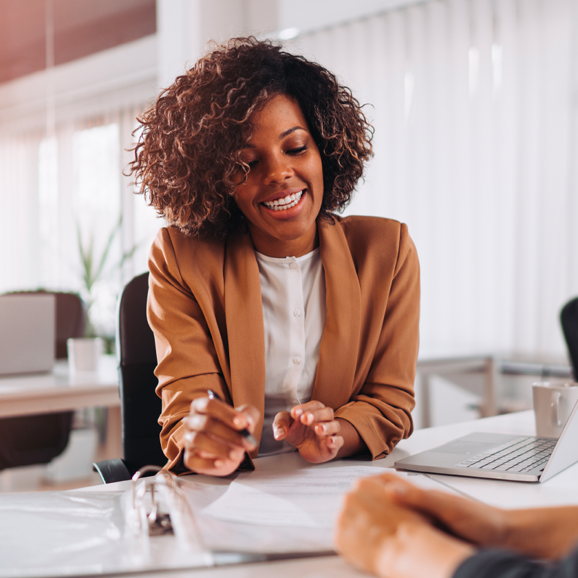 A woman in a business suit consult a client.