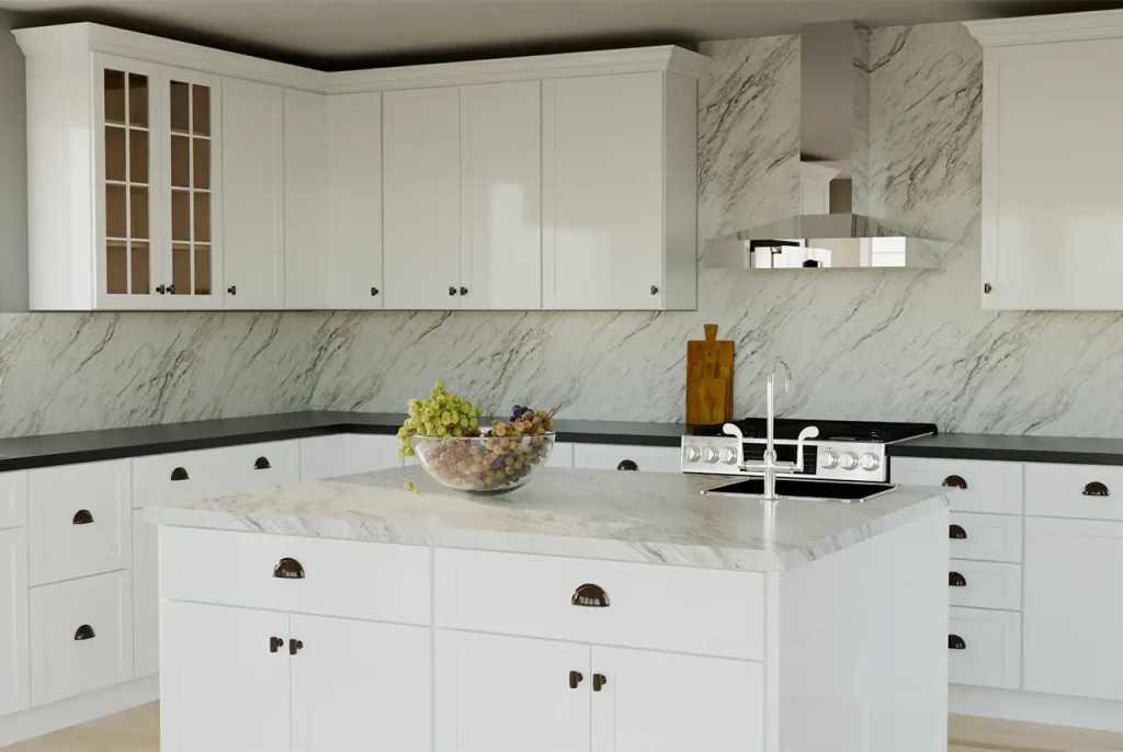 Classic white kitchen with marble backsplash – A traditional white kitchen with shaker cabinets, a marble backsplash, and a large center island with a fruit bowl.