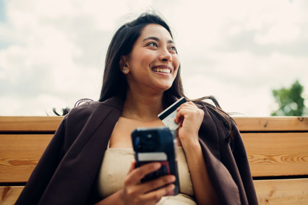 A woman holding a credit card in her hand