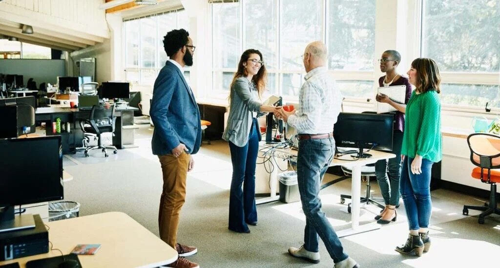 A group of professionals engaged in discussion in a modern office