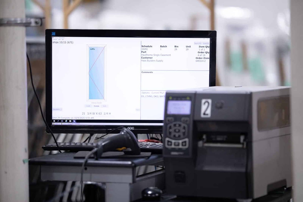 A factory scene featuring a computer monitor and printer