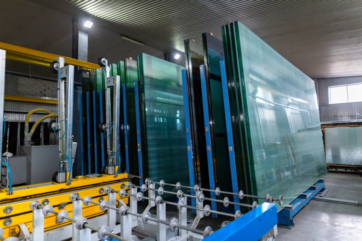 Factory for the production of double-glazed windows made of sheet glass. Sheet glass in pallets near the sheet glass cutting line